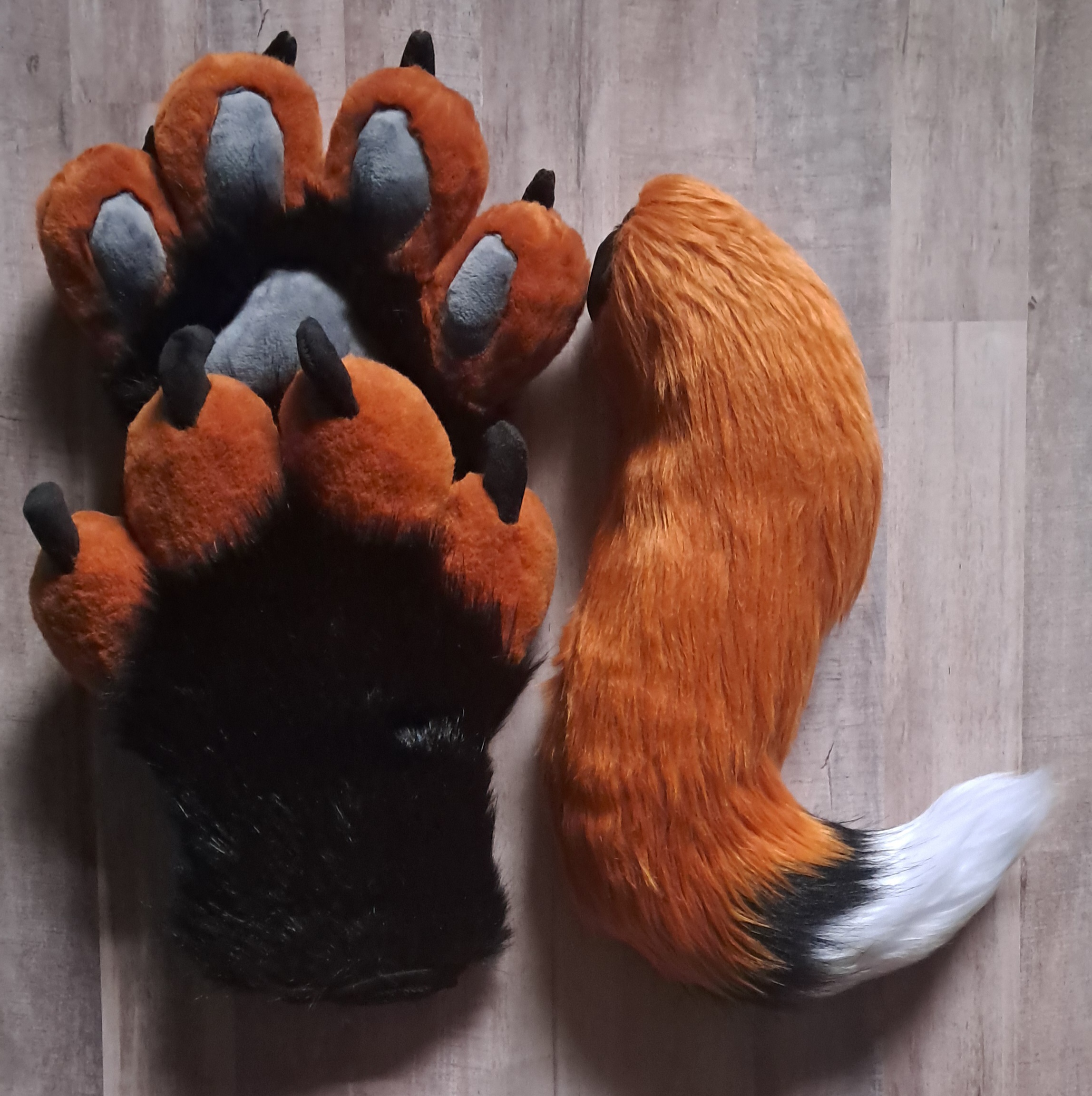 Rusty orange fox tail and handpaws